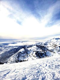 Scenic view of snow covered mountains against sky