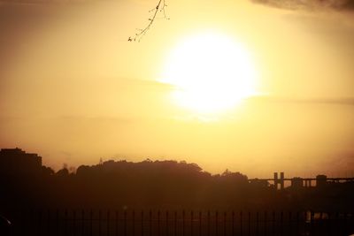 Silhouette buildings against sky during sunset