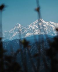 Scenic view of snowcapped mountains against clear sky