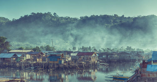 Panoramic view of lake and buildings against sky