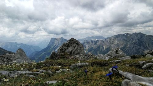 Scenic view of mountains against cloudy sky