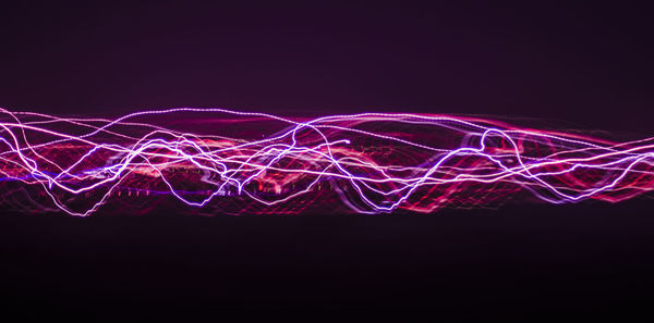 Illuminated light painting against black background