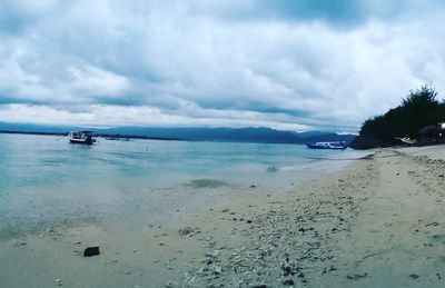 Scenic view of sea against cloudy sky