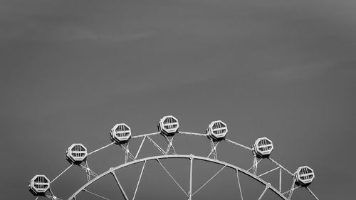 Low angle view of ferris wheel against sky