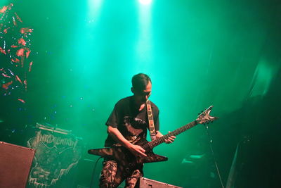 Man playing guitar at music concert