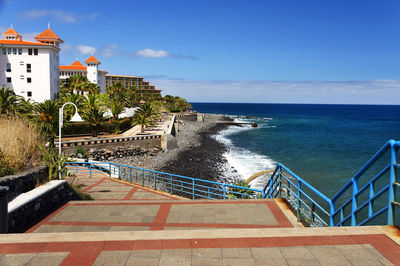 Built structures against calm blue sea