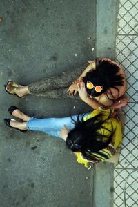 Directly above shot of women sitting on road