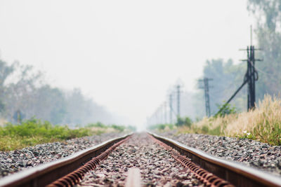 Surface level of railroad track against clear sky