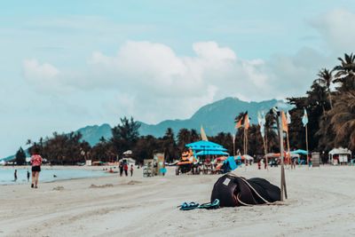 People on beach against sky