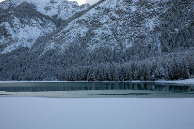 Scenic view of frozen lake by snowcapped mountains