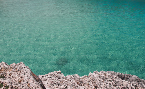 High angle view of rocks by sea