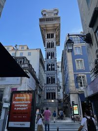 People on street amidst buildings in city