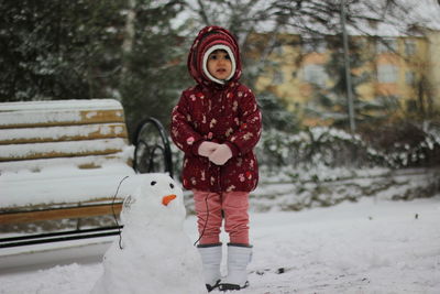 Portrait of woman standing in snow