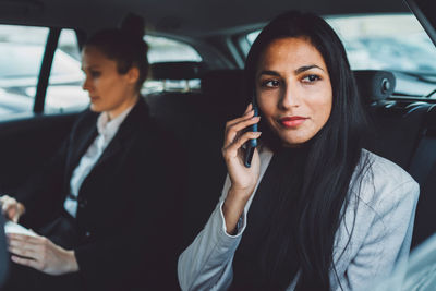 Portrait of young woman in car