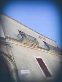 Low angle view of building against clear blue sky