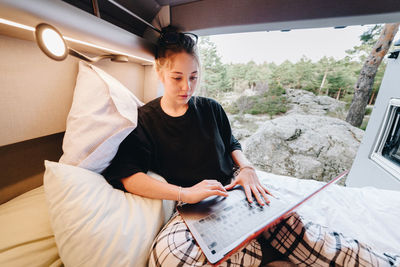 Woman using laptop in motor home