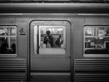 People on train at railroad station