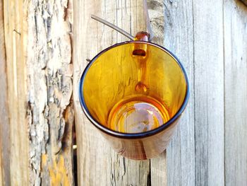 Glass cup hanging on wooden boards