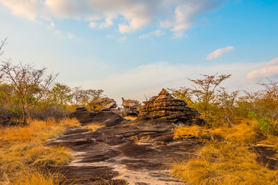 Rock formations on landscape against sky