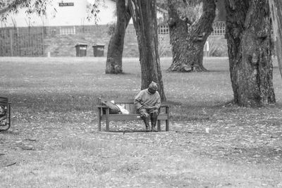 Man sitting on bench in park