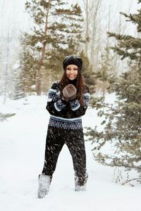 Portrait of woman standing on snow