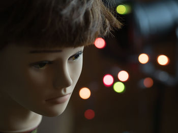 Close-up of doll against illuminate lighting equipment