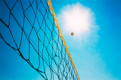 Low angle view of volleyball net against clear blue sky