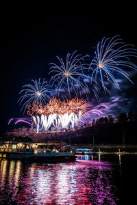 Low angle view of firework display at night