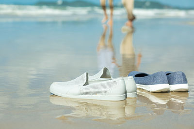 Low section of shoes on beach