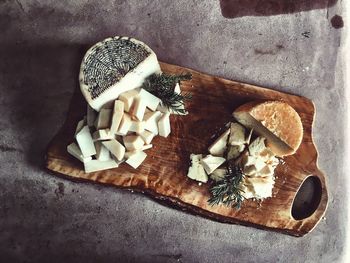 High angle view of cheese plate on wooden cutting board
