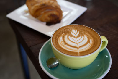 High angle view of cappuccino and coffee on table