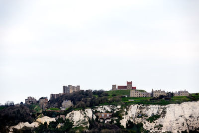 Buildings in city against clear sky