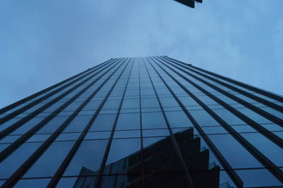 Low angle view of skyscraper against clear blue sky