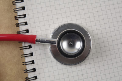 Directly above shot of stethoscope on spiral notebook