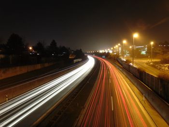 High angle view of light trails on highway at night