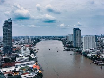 High angle view of buildings against cloudy sky