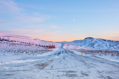 Scenic view of snow mountains against sky during sunset