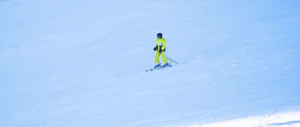 Full length of man skiing on snowy field