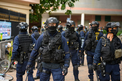 Police force standing on street