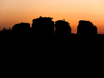 Low angle view of silhouette buildings against sky during sunset