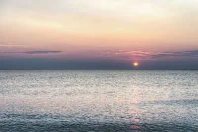 Scenic view of sea against romantic sky at sunset