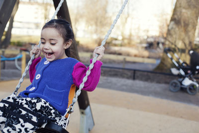 Happy girl swinging
