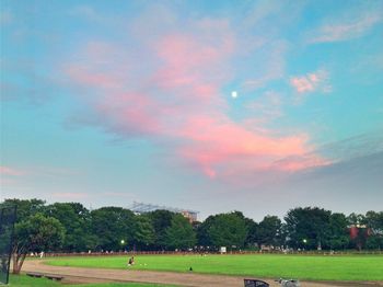 Scenic view of grassy field against cloudy sky