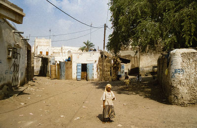 Rear view of woman walking on street in city