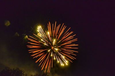 Low angle view of firework display at night