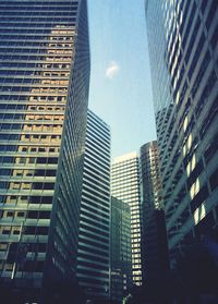 Low angle view of modern buildings in city against sky