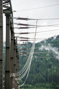 Low angle view of electricity pylon against sky