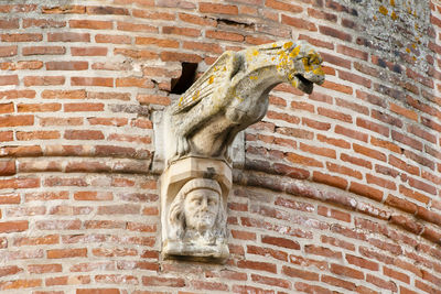 Low angle view of carving on brick wall