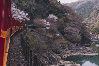 Train on railroad track by mountain