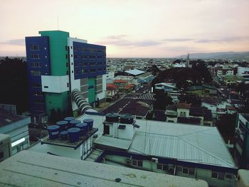 Buildings against cloudy sky